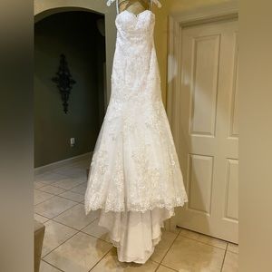 Never worn,white,size 2,strapless fit and flare, chapel train with veil included